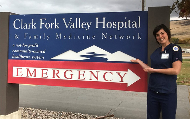 woman by hospital sign