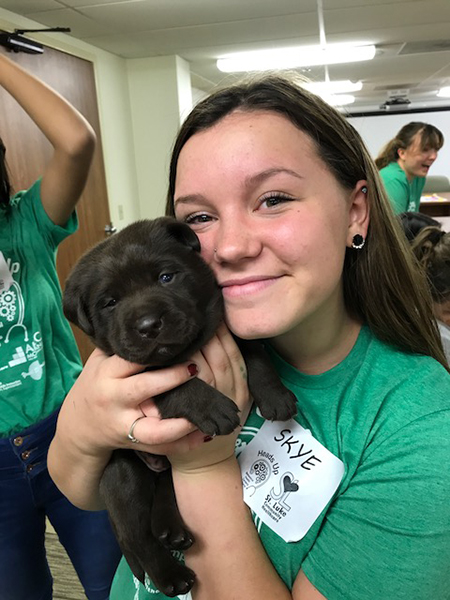 student with a puppy